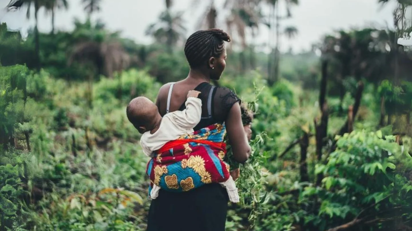 an image of an African mom carrying a child